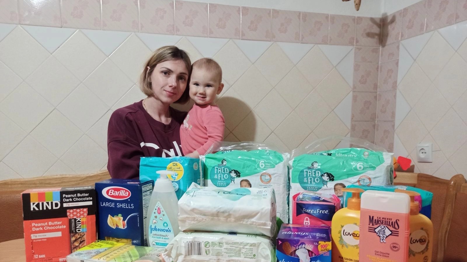 Khemelnitskiy, Ukraine mother and infant with humanitarian aid delivered by iLoveUkraine in partnership with the Catholic Church of Khemelnitskiy.