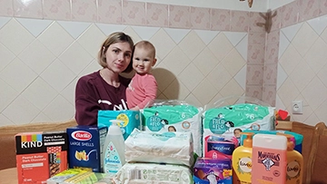 Khemelnitskiy, Ukraine mother and infant with humanitarian aid delivered by iLoveUkraine in partnership with the Catholic Church of Khemelnitskiy.