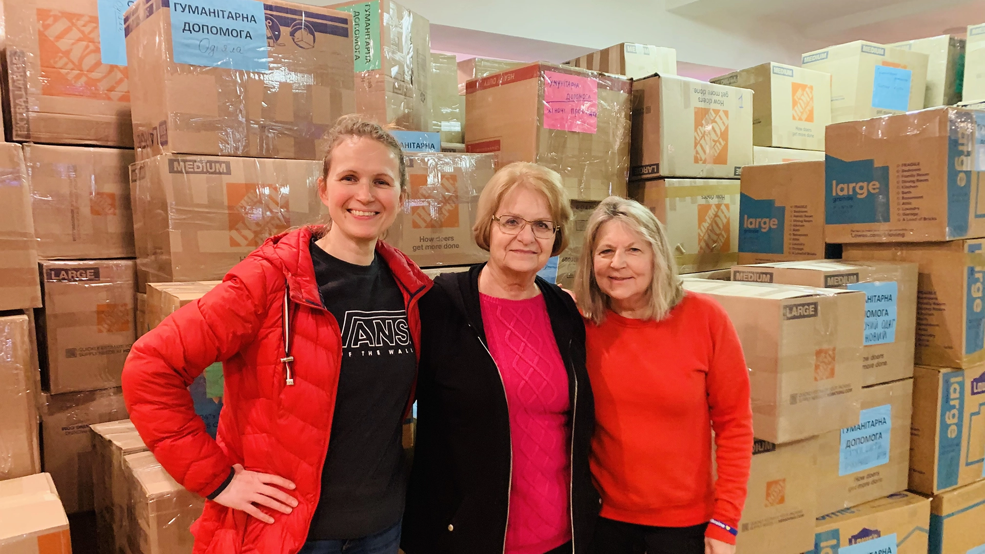 iLoveUkraine podcast producer, Bernadette Ruggiero, and volunteers with donations at the Southampton Greek Orthodox Church.